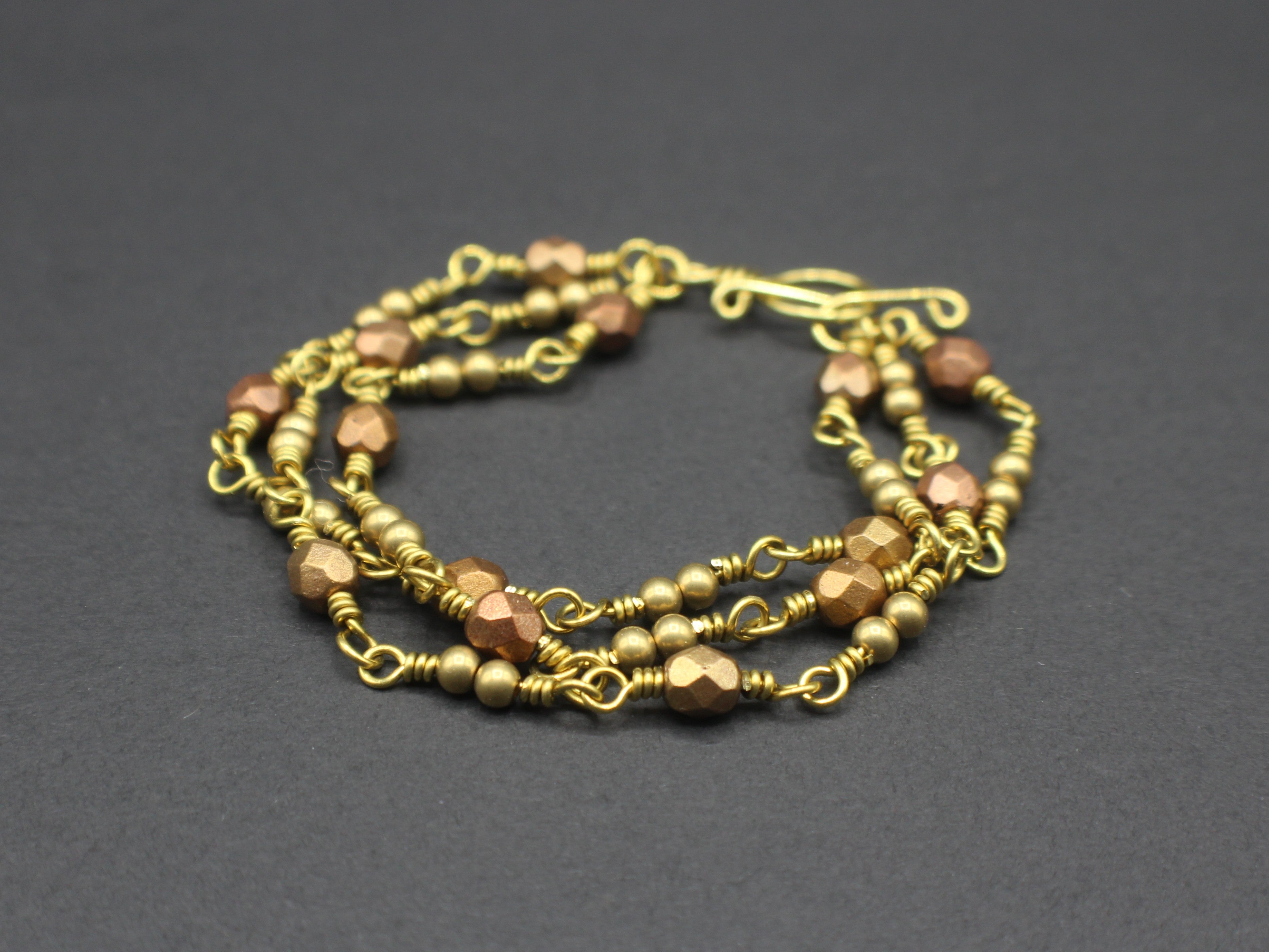 Handcrafted Triple Strand Metallic Faceted Glass and Brass Bracelet with Toggle Clasp, 6.5"