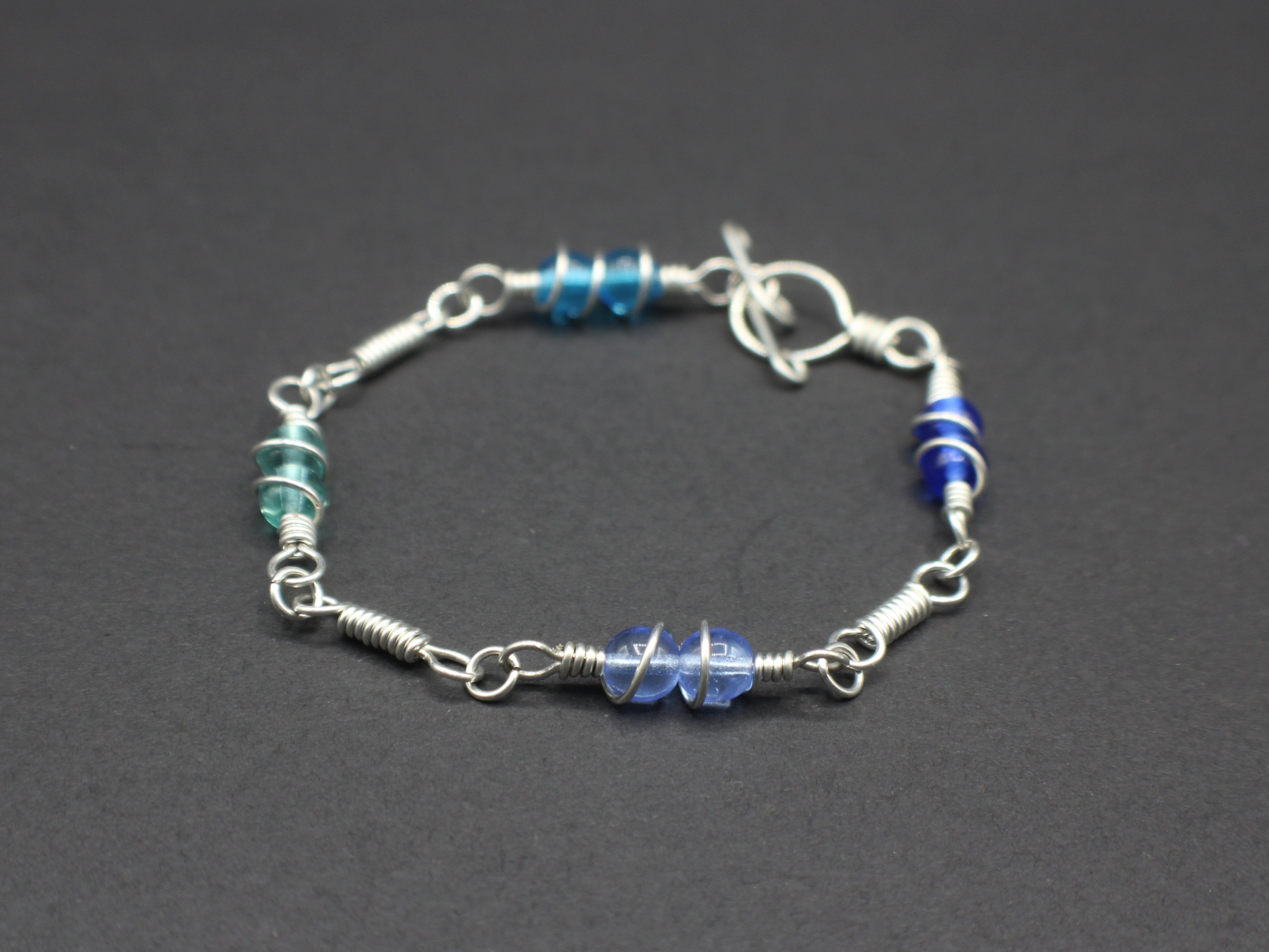 Handcrafted Single Strand Czech Glass Bracelet in Blue and Green with Spiral Wraps, 6.75"